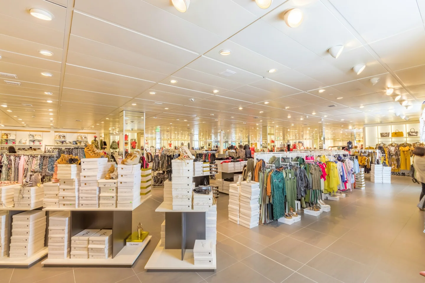 Clothing racks and shoe displays inside a retail store