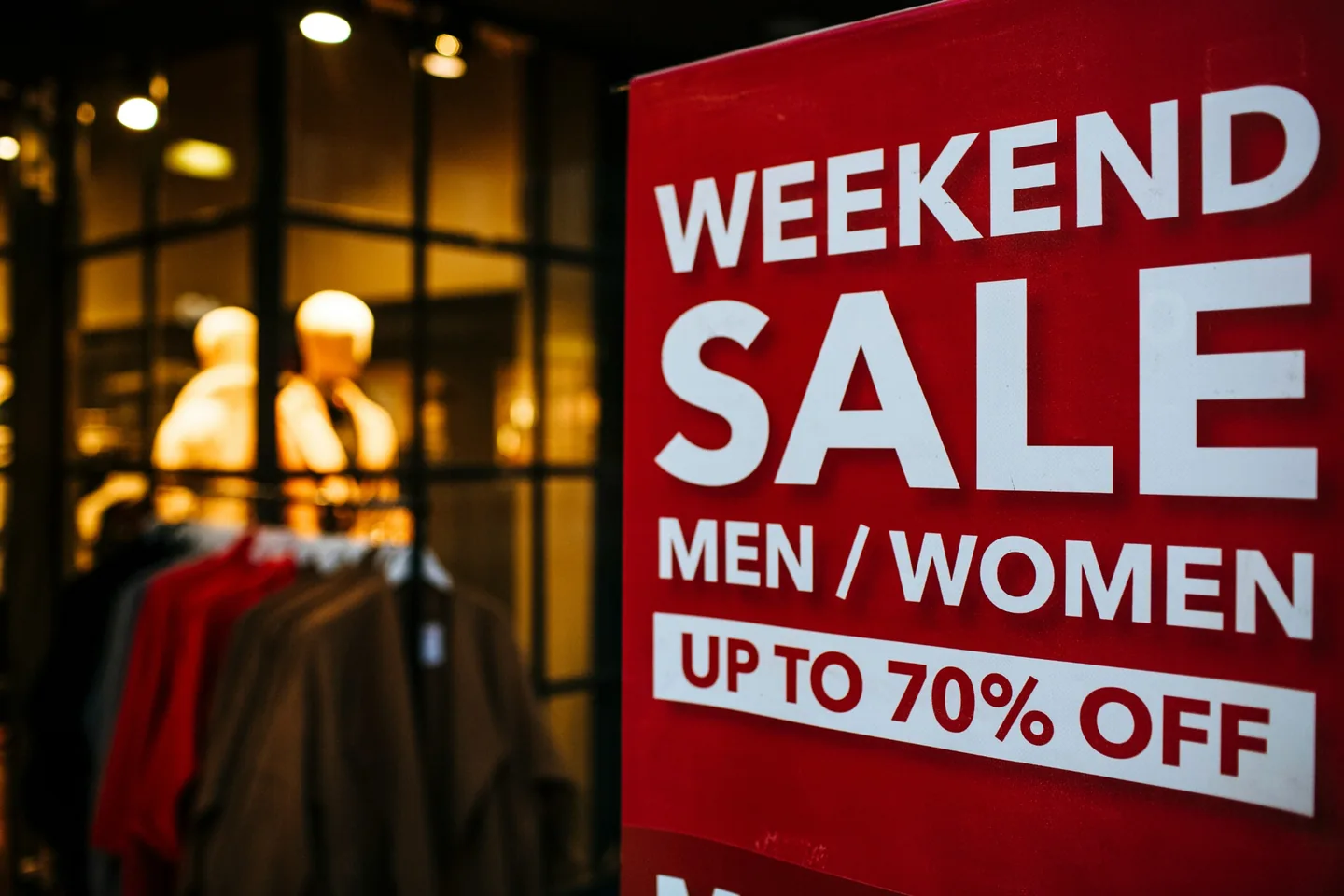 A retailer window displaying a sale sign
