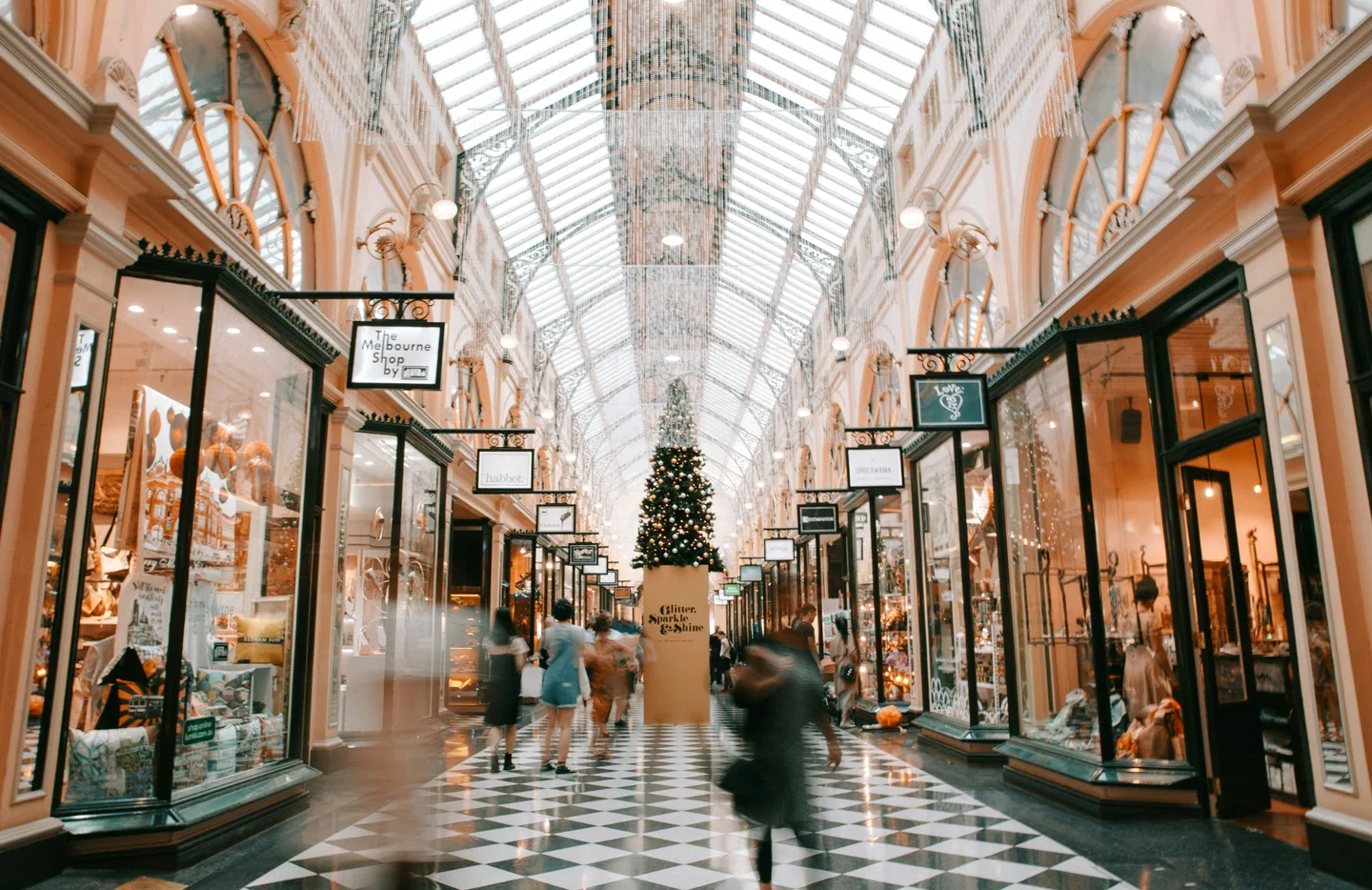 Shoppers walking through a covered shopping arcade